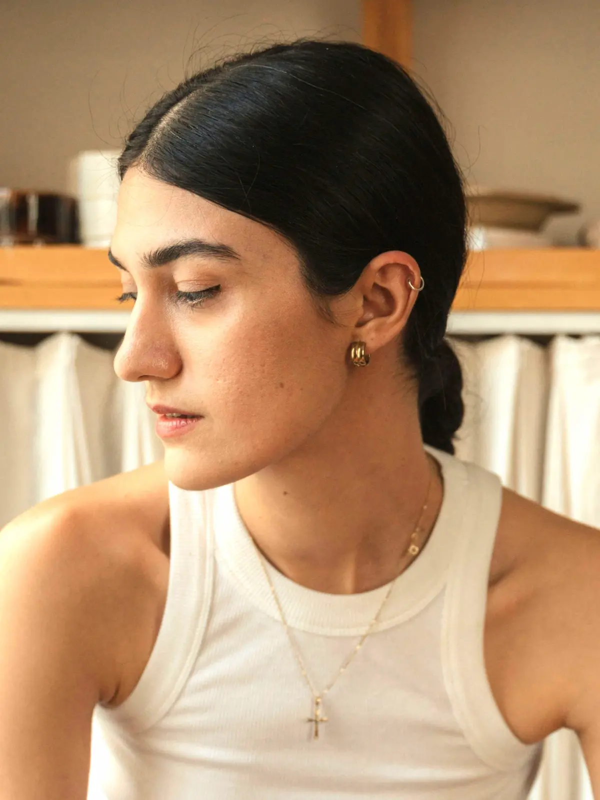 Donna seduta su uno sgabello con un cerchietto al piercing helix